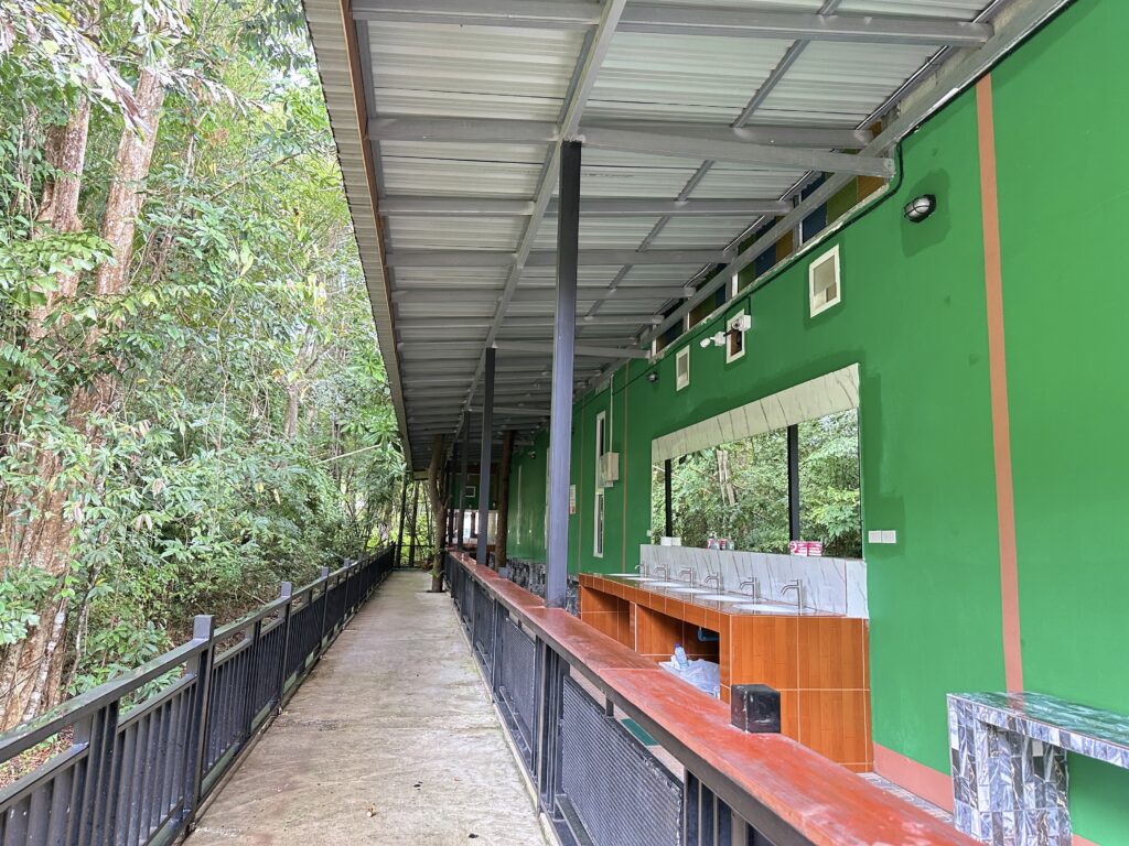 Covered outdoor walkway and communal area at Khao Sok Jungle Hostel Branch 2 - a leading Khao Sok hostel for big groups